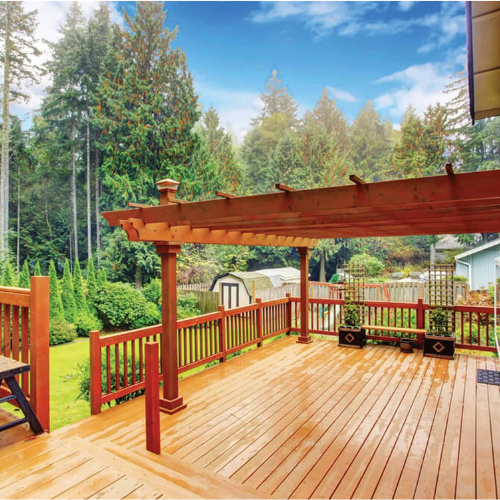 Design of deck and porch outside the house with a green scenery.